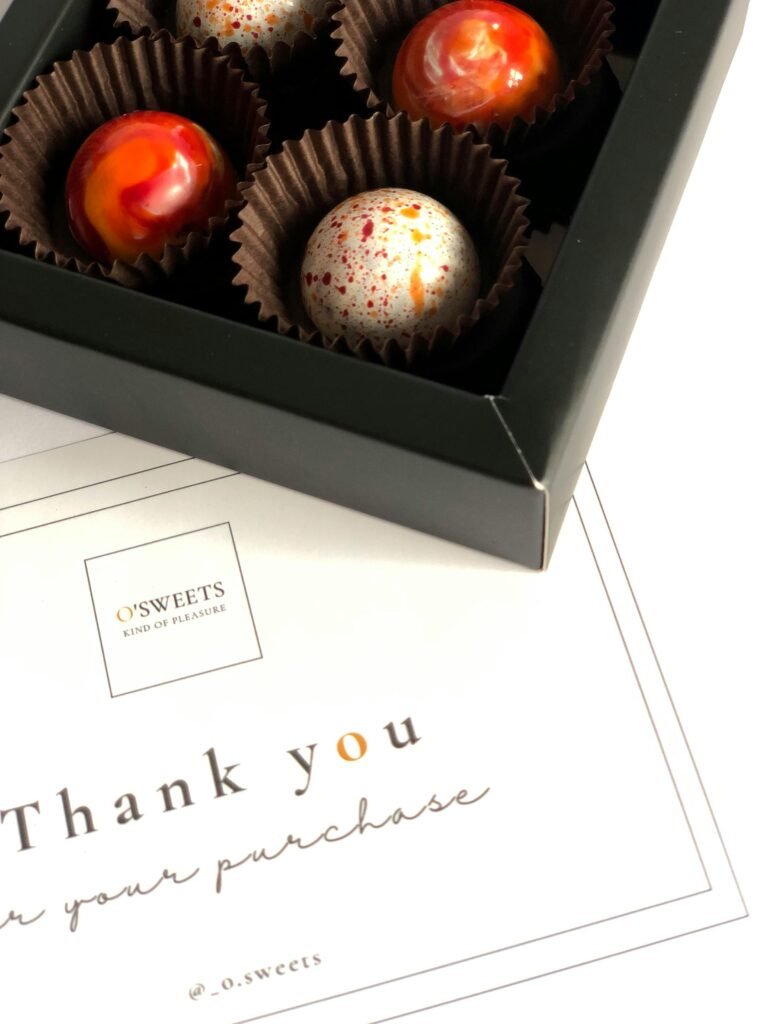 pexels-photo-14275578-14275578 A sophisticated box of gourmet chocolates with an elegant presentation card.