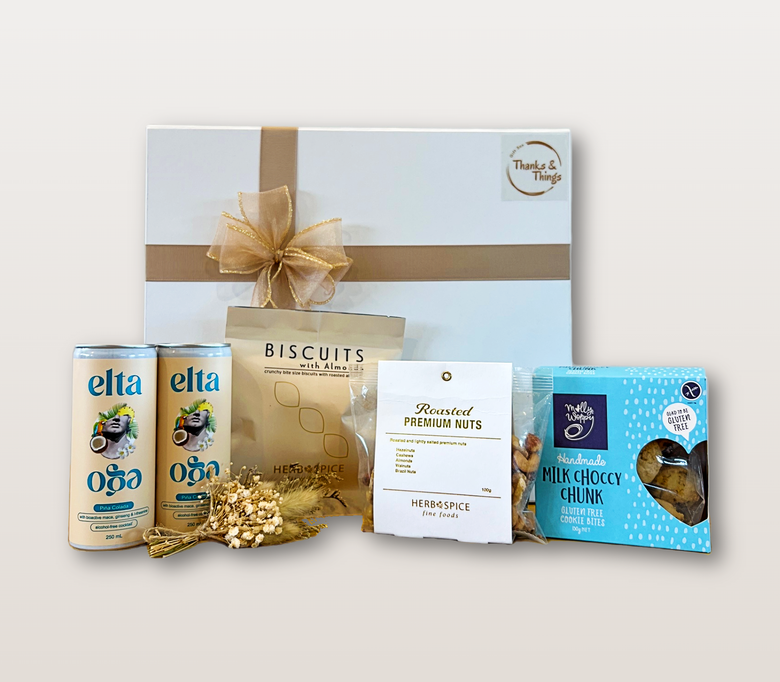 Caribbean Dream Gift Box NZ with alcohol-free Piña Coladas, almond biscuits, premium nut mix, gluten-free chocolate cookie bites, and dry flower mini bouquet