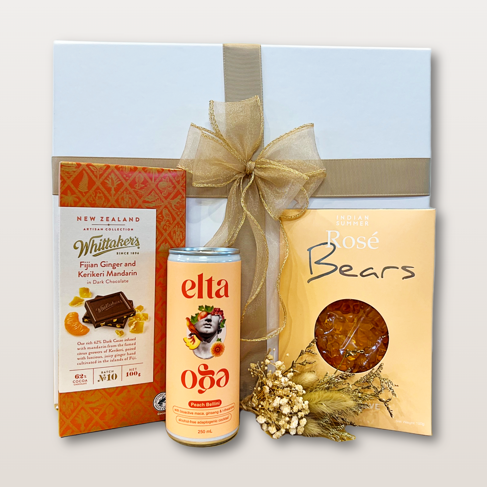 Petit Bellini Gift Box NZ with alcohol-free Peach Bellini, Whittaker’s chocolate, pink rosé Bubbly Bears, and dry flower mini bouquet
