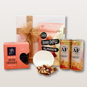 Petit Bliss Gift Box NZ with alcohol-free pink grapefruit spritzers, berry-dusted almonds, salted chocolate cookie bites, white dip bowl, and dry flower mini bouquet